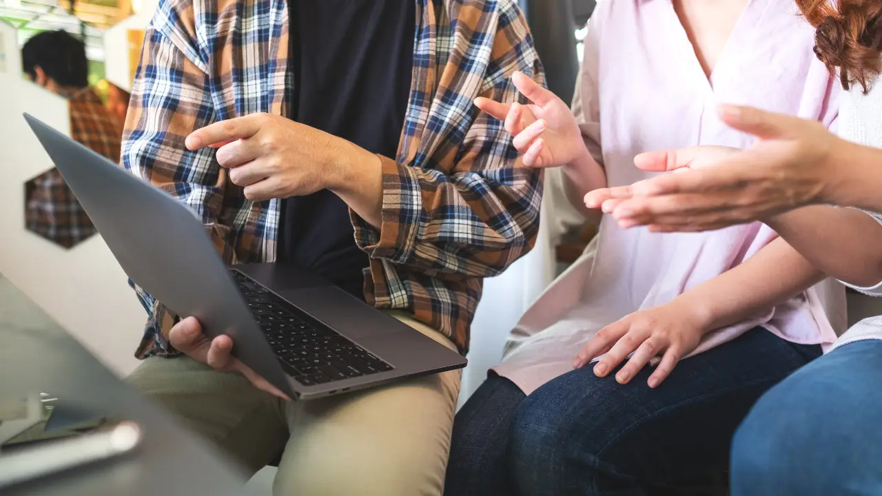 Person pointing at a laptop screen, symbolizing future search technology.