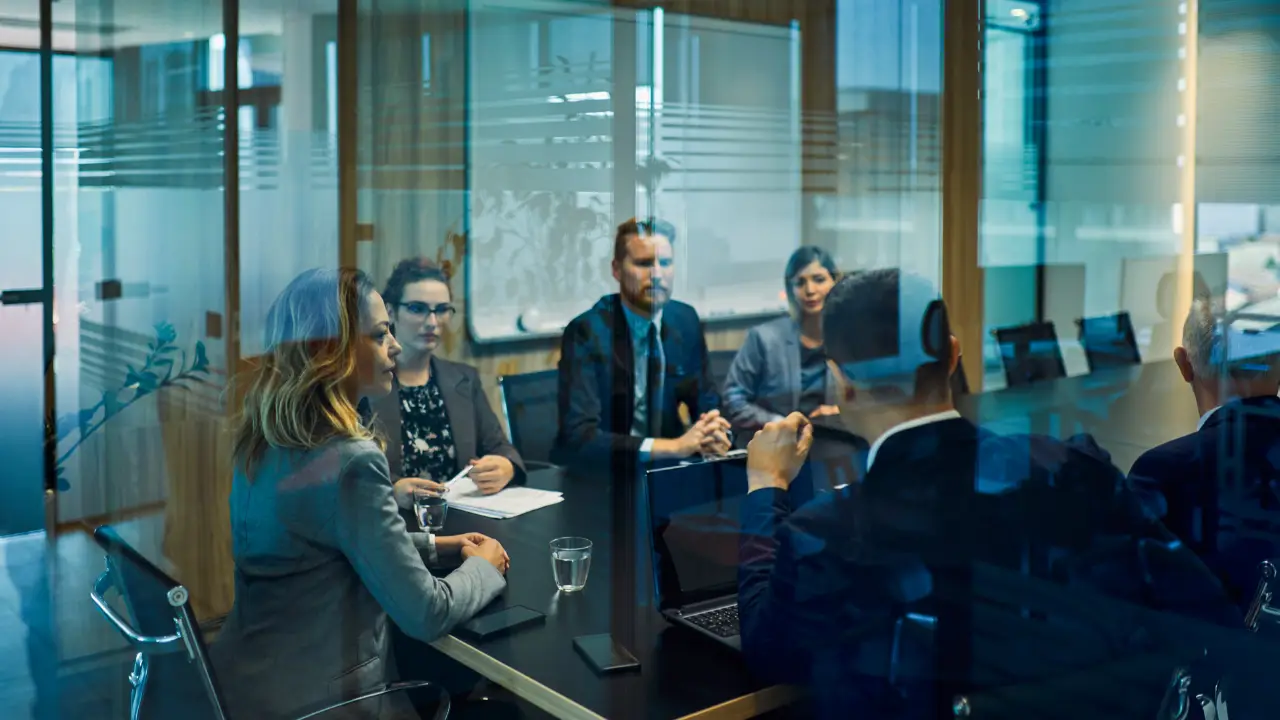 Executive boardroom meeting discussing SEO governance and enterprise visibility strategy